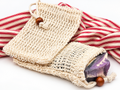 Natural sisal soap saver pouches with a purple handmade soap bar
